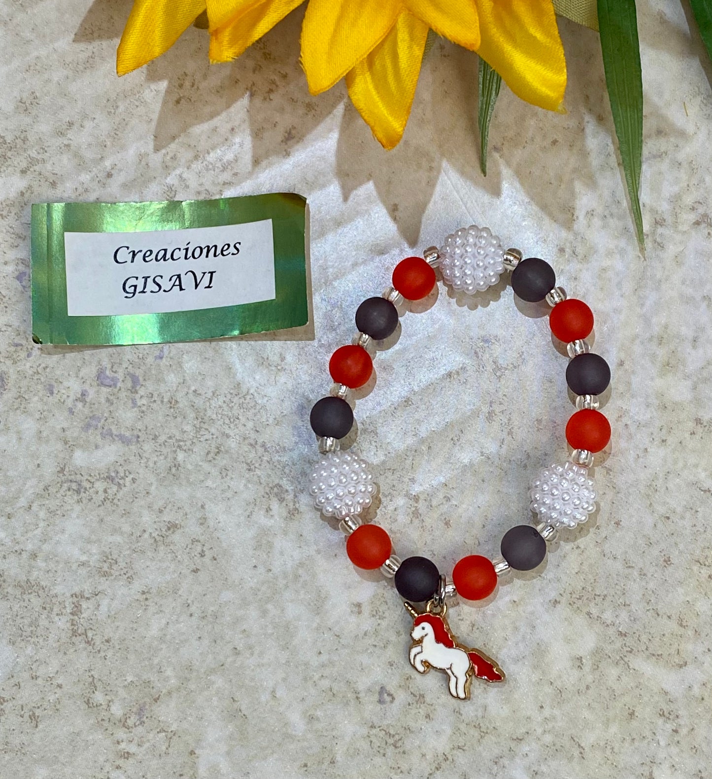 Flower bracelet. Unicorn charm. White, red and black. 6”